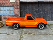 Hot Wheels Datsun 620 orange with yellow stripes and Bridgestone graphics, right side view