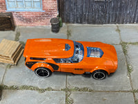 Hot Wheels Drift'n Break metallic orange, top view with visible play wear