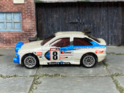 Hot Wheels Escort Rally white and blue number 8 Swisher Motors, left side view