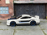Hot Wheels Ford Shelby GT350R white with black and blue stripes, left side view