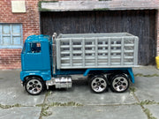 Hot Wheels Ford Stake Bed Truck teal cab and gray bed, left side view