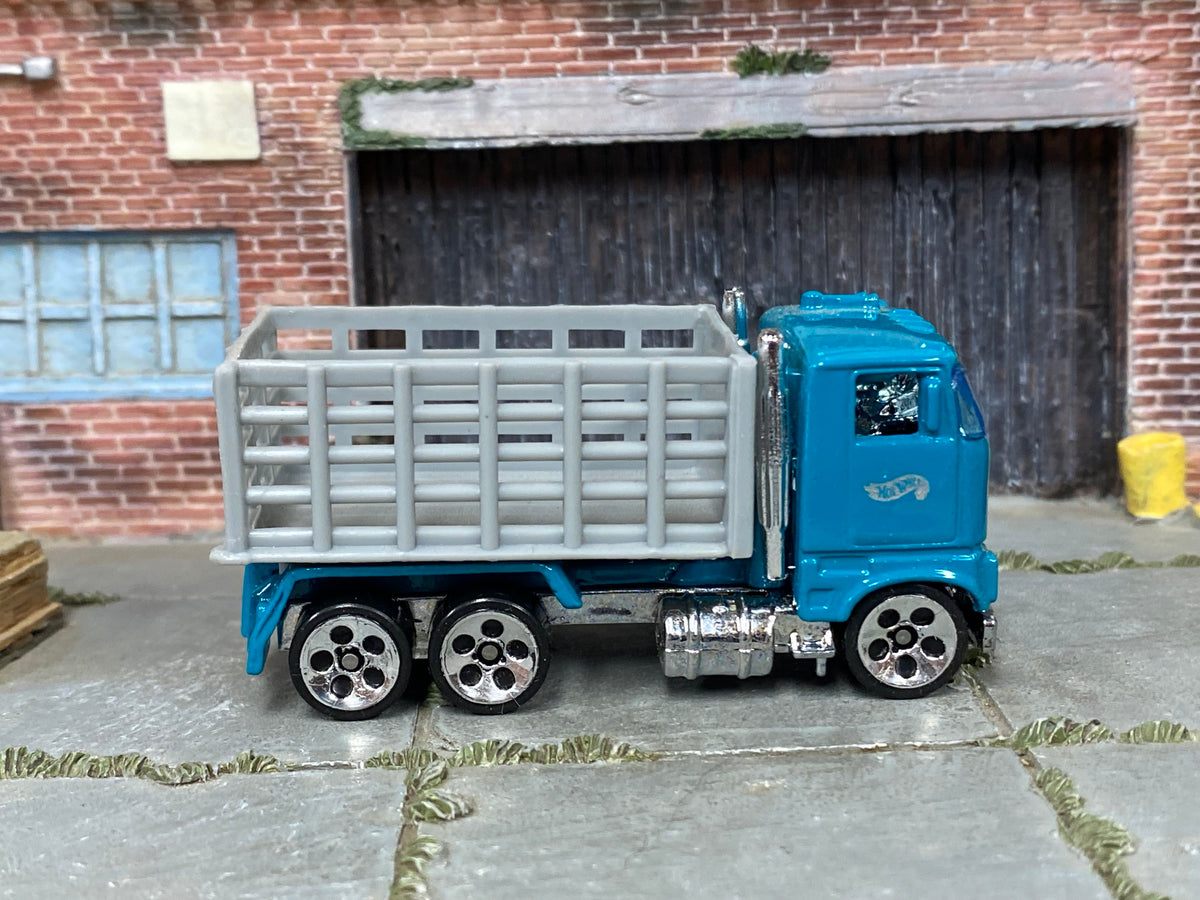 Hot Wheels Ford Stake Bed Truck teal cab and gray bed, right side view