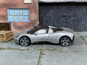 Silver Hot Wheels Gordon Murray Automotive T.33, left-side view of loose car