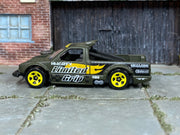 Hot Wheels Limited Grip olive and yellow loose truck, left side view