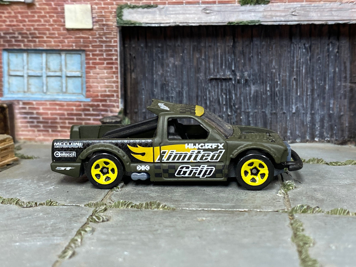 Hot Wheels Limited Grip olive and yellow loose truck, right side view