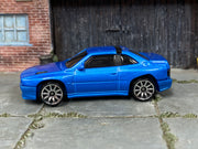 Hot Wheels Maserati Shamal metallic blue with black roof trim, left side view