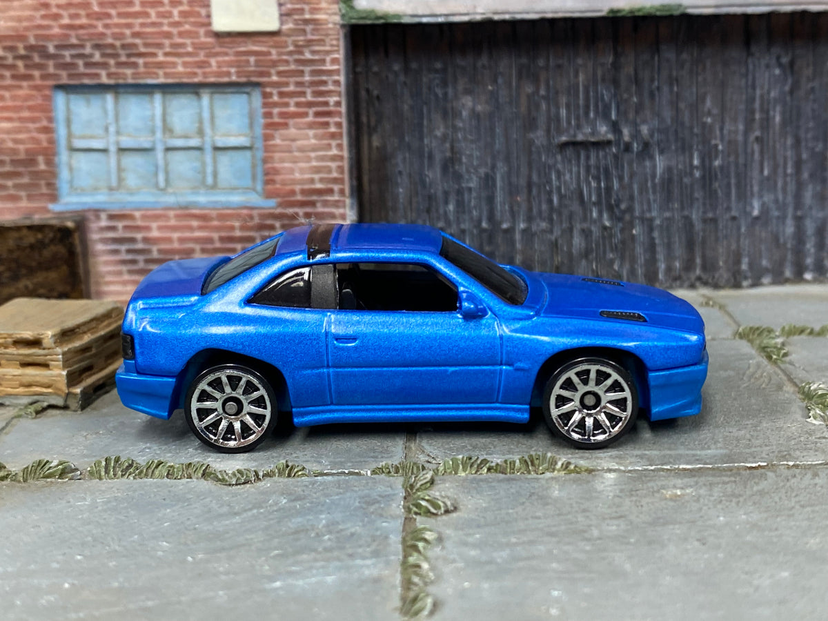 Hot Wheels Maserati Shamal metallic blue with black roof trim, right side view