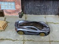 Hot Wheels McLaren P1 metallic gray loose car with gold wheels, top view