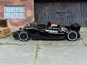 Hot Wheels Mercedes-AMG Petronas Formula One Team black and turquoise loose car, left-side view