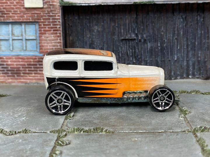 Hot Wheels Midnight Otto pearl white with orange and black graphics, right side view