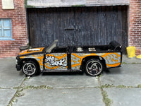 Hot Wheels Mini Truck black and orange Street Art, left side view with visible play wear
