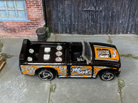 Hot Wheels Mini Truck black and orange Street Art, top view with visible play wear