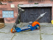 Hot Wheels Mo Scoot clear blue miniature scooter with orange wheels, left side view