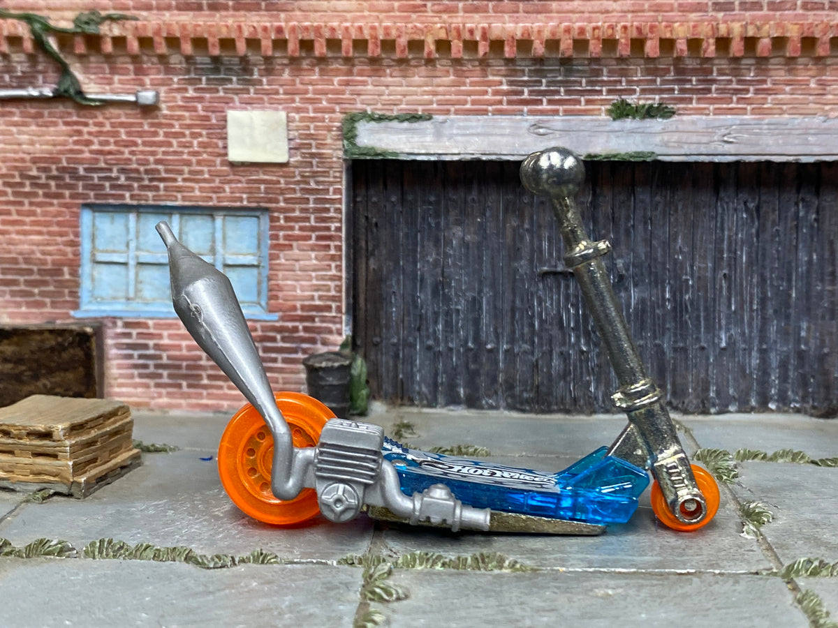 Hot Wheels Mo Scoot clear blue miniature scooter with orange wheels, right side view