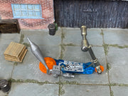 Hot Wheels Mo Scoot clear blue miniature scooter with orange wheels, top view