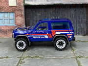 Hot Wheels Nissan Patrol Custom blue Hill Climb Race Team, left side view