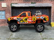 Hot Wheels Nissan Truck Mixed Signals orange, left-side view