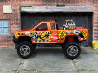 Hot Wheels Nissan Truck Mixed Signals orange, left-side view