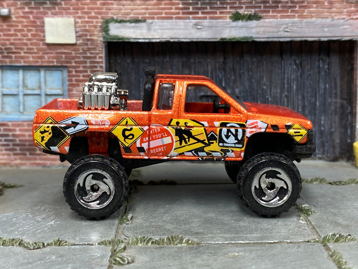Hot Wheels Nissan Truck Mixed Signals orange, right-side view