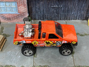 Hot Wheels Nissan Truck Mixed Signals orange, top view