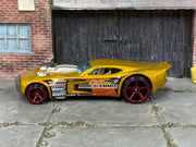 Hot Wheels Nitro Doorslammer metallic gold with red wheels — left side view