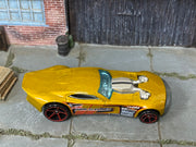 Hot Wheels Nitro Doorslammer metallic gold with red wheels — top view