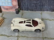 Hot Wheels Pagani Utopia in pearl light gray, top view of loose car