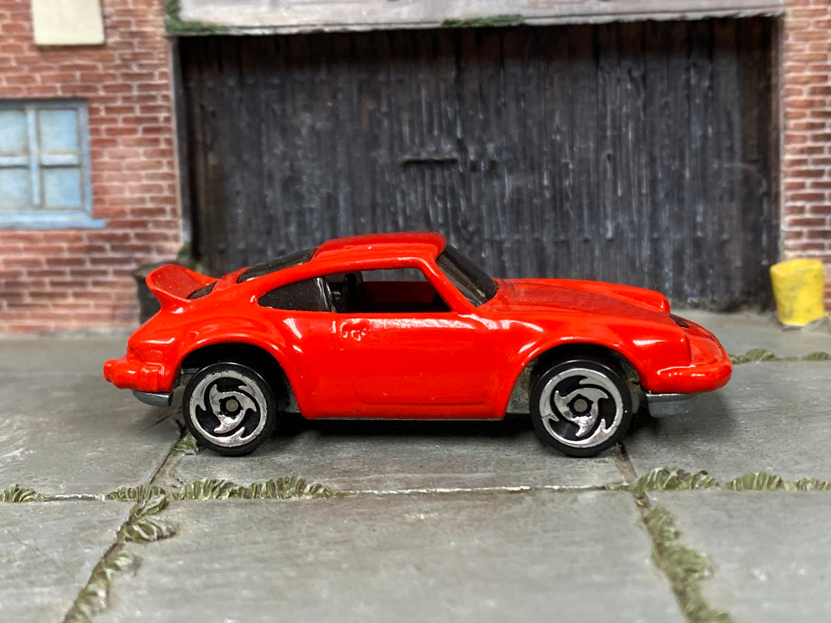 Hot Wheels Porsche P-911 red with silver three-spoke wheels, right side view