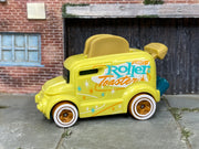 Hot Wheels Roller Toaster yellow with turquoise and orange graphics, left side view