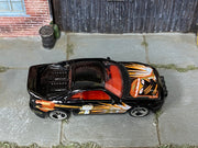 Hot Wheels Saleen S7 black with orange and gold fist graphics top view