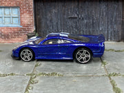 Hot Wheels Saleen S7 metallic blue and white, left side view with visible loose-car wear