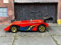 Hot Wheels Shadow Mk IIa red with blue and yellow graphics, left side view