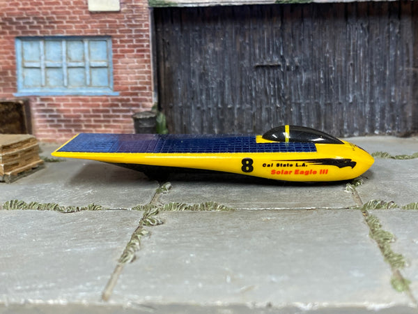 Hot Wheels Solar Eagle III yellow and blue number 8 loose car, right side view