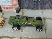 Hot Wheels Super Cannon olive camouflage with white five-spoke wheels, top view