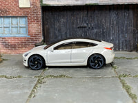 Hot Wheels Tesla Model 3 pearl white loose car, left side view