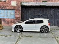 Hot Wheels Volkswagen Golf GTI pearl white with black hood, left-side view