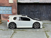 Hot Wheels Volkswagen Golf GTI pearl white with black hood, right-side view