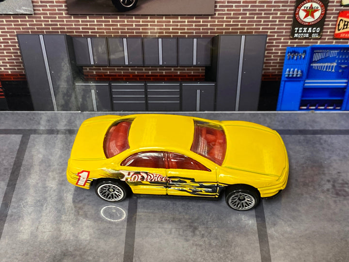 Loose Yellow Oldsmobile Aurora Hot Wheels — view 2