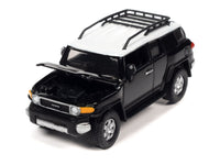 Johnny Lightning 1:64 2007 Toyota FJ Cruiser in Black Diamond with white roof and roof rack, hood open.