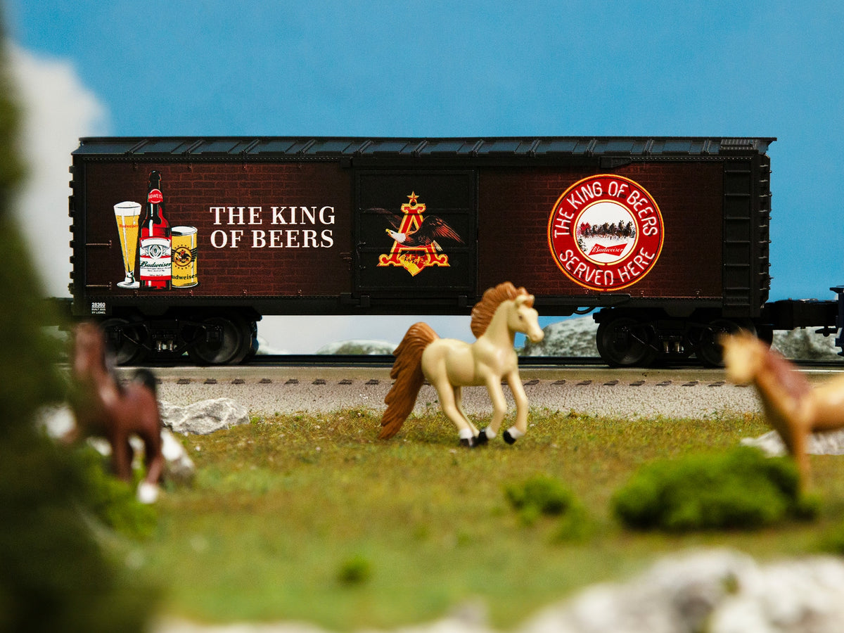 Lionel 2528360 Budweiser Illuminated Bar Sign #2 O gauge boxcar shown in a model-railroad scene.
