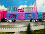 Lionel 2528460 Barbie 1980s boxcar displayed on a layout; scenery and other cars not included