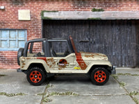 Matchbox Jeep Wrangler Jurassic Park Tour Jeep Gold and Red Muddy - rear angle view showing tampo details