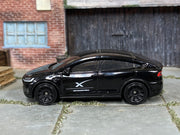 Matchbox Tesla Model X black SpaceX Crew Transport — left-side view