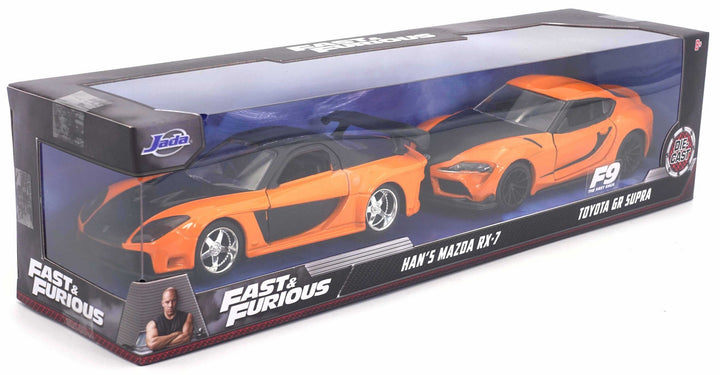 Both cars in the Jada 32910 twin pack: orange and black Mazda RX-7 and Toyota GR Supra together in Fast & Furious window packaging