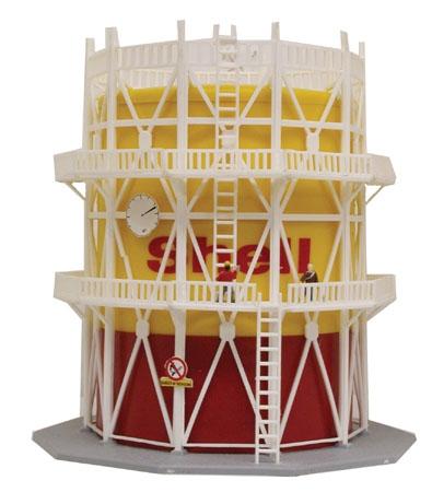 Model Power 2590 N scale built-up large oil storage tank, yellow and red Shell tank with white framework, ladders, platforms and figures.