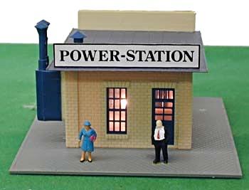 Model Power 580 HO scale built-up Power Station, front view showing the illuminated building and two painted figures. Green display surface is not included.