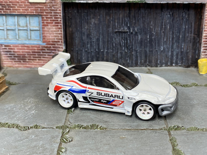 Subaru BRZ custom Hot Wheels in white rally livery with white wheels and rubber tires