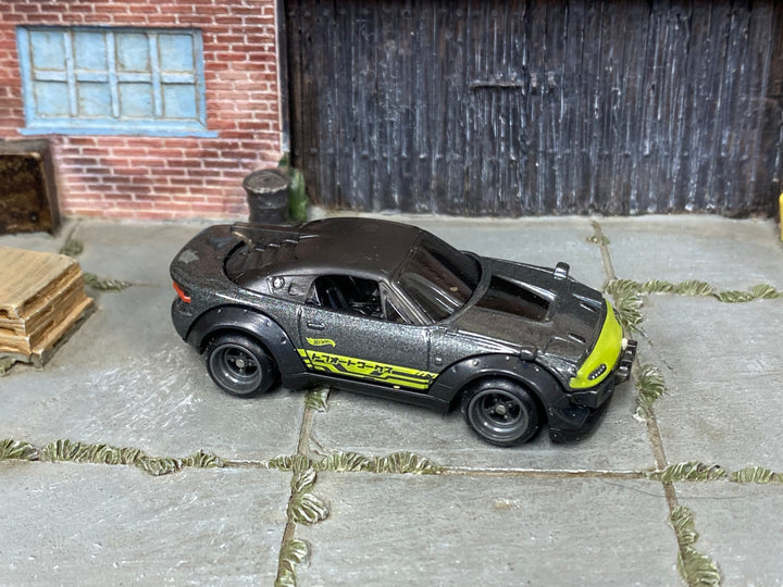 Mazda RX-7 custom Hot Wheels in dark gray and lime with gray wheels and rubber tires