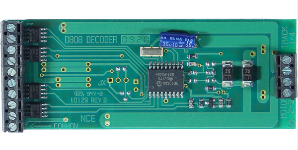 NCE 524-112 D808 decoder — close-up of the labeled circuit board and screw terminals.