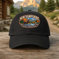 New Hampshire heritage badge on a black embroidered dad hat outdoors